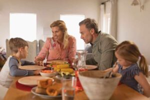 Eine Familie versammelt sich an einem Tisch und genießt ein gemeinsames Essen.